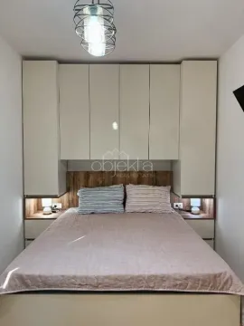 Furnished bedroom with a double bed and built-in wardrobes. - image 11