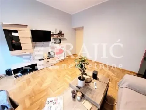 Living room with furniture, TV, and parquet flooring. - image 4