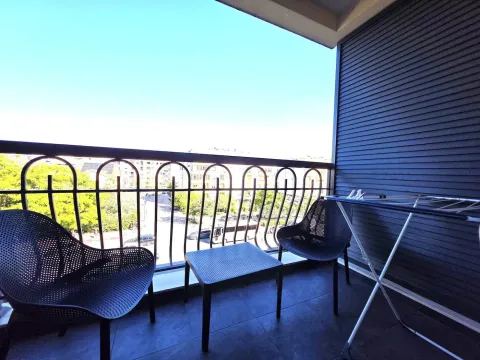 Furnished balcony with seating set and street view. - image 6