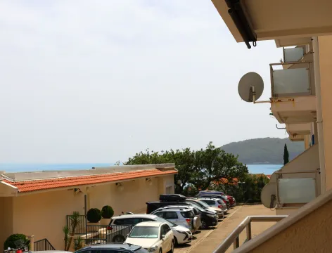 View from the terrace overlooking the parking lot and surrounding buildings. - image 4