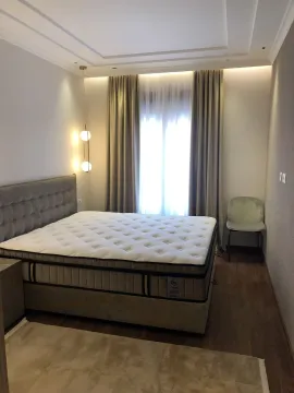 Bright bedroom featuring a large double bed and modern lighting. - image 11