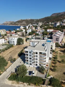 Pogled iz vazduha na modernu stambenu zgradu sa okolnim naseljem i pogledom na more. - image 17