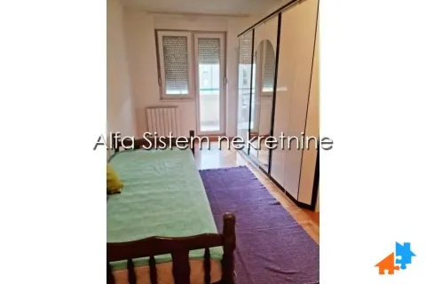 Bedroom with a bed, large wardrobe, and balcony access. - image 9