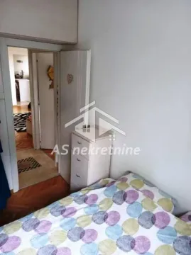 A view of the bed in the bedroom with a door leading to the hallway. - image 9