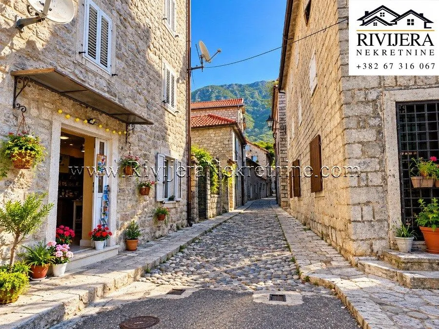A street in the old town with stone houses and cobblestone pavement.