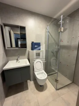 Moderno opremljeno kupatilo sa tuš kabinom, umivaonikom i WC šoljom. - image 5