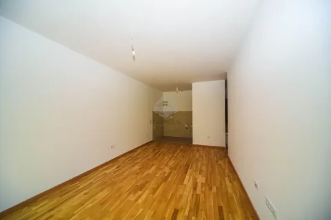 Empty room with wooden parquet flooring and white walls. - image 2