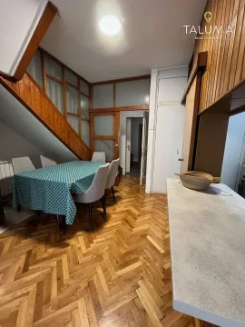 Dining area with a wooden staircase and parquet flooring. - image 6