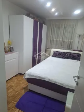 Furnished bedroom with a double bed, large wardrobe, and parquet flooring. - image 8