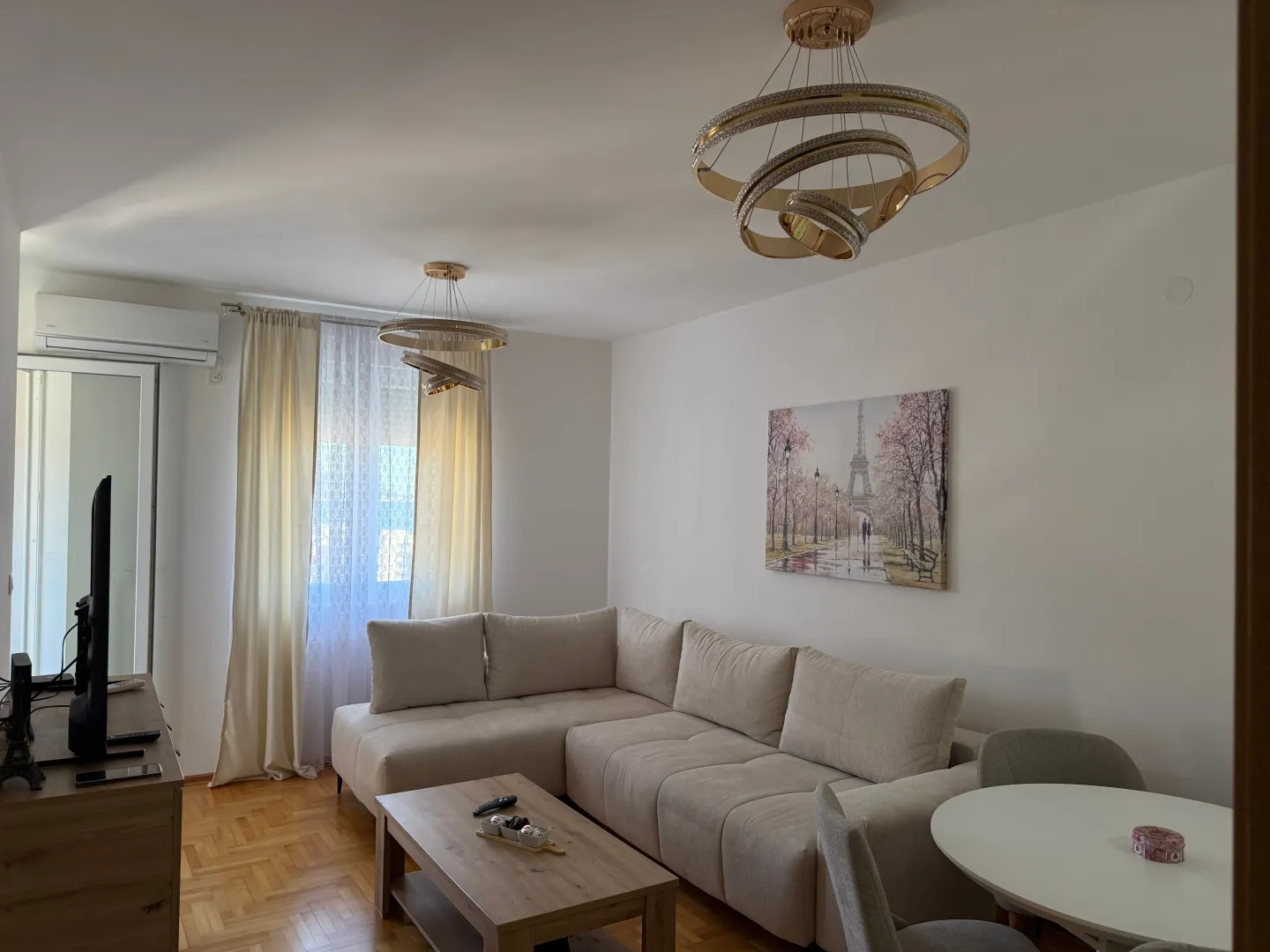 Living room with a sectional sofa, coffee table, and dining table.