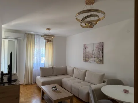 Living room with a sectional sofa, coffee table, and dining table. - image 6
