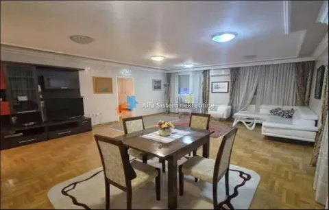 Spacious living room with a dining area, sofa set, and television. - image 5