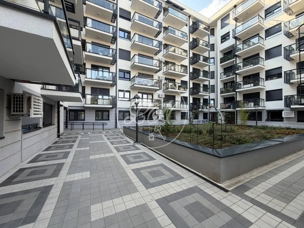 View of the courtyard and the facade of the residential building with balconies.