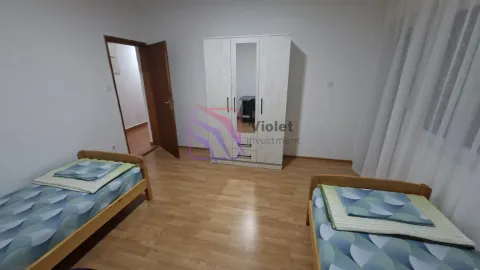 Bedroom with two single beds and a white wardrobe. - image 13