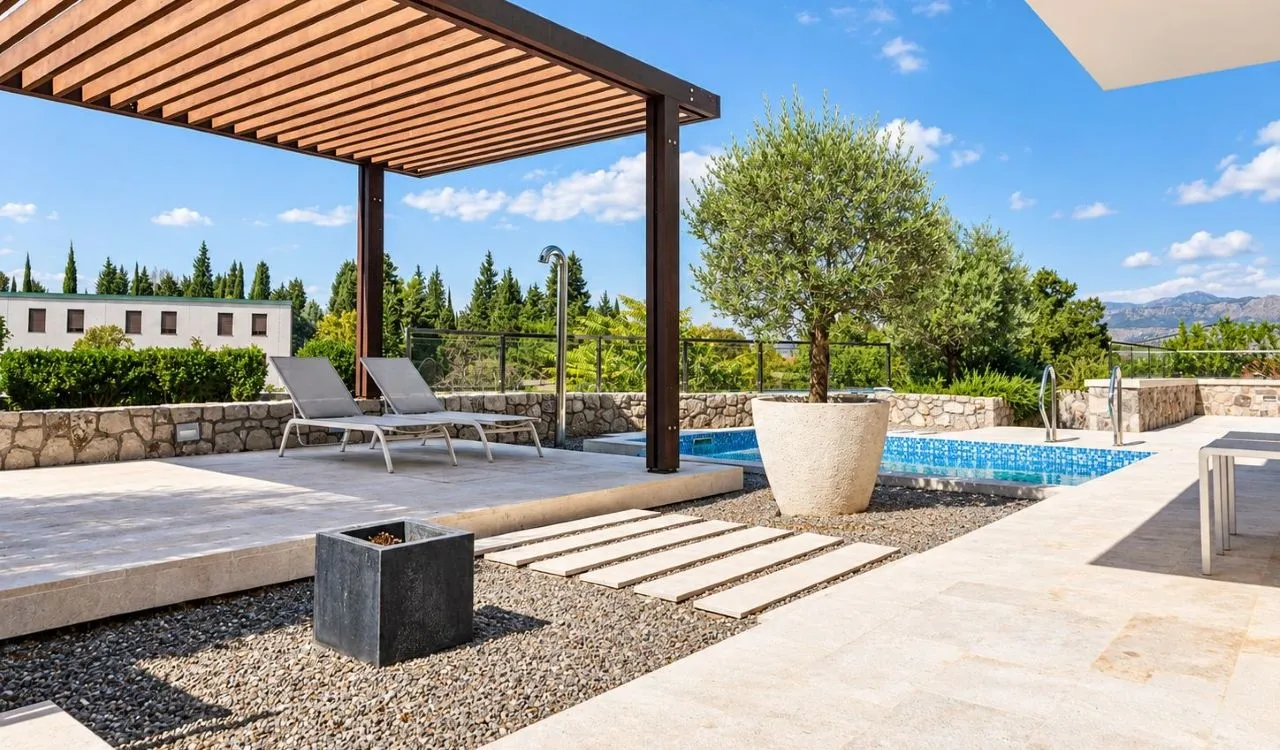 Yard with a swimming pool, pergola, and sun loungers.
