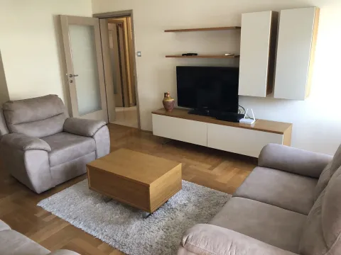 Bright living room with a seating set and a TV. - image 4