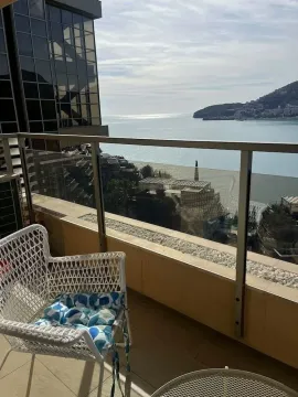 Balcony with a glass railing and a view of the sea and coast. - image 13