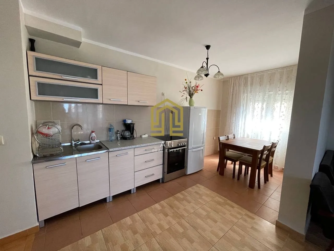 Manja kuhinja sa trpezarijom i elementima od svijetlog drveta.