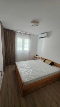 Modern bedroom with a double bed, wooden flooring, and decorative wall panels. - image 5