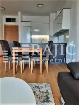 Living room with dining area and kitchen in the background. - image 3