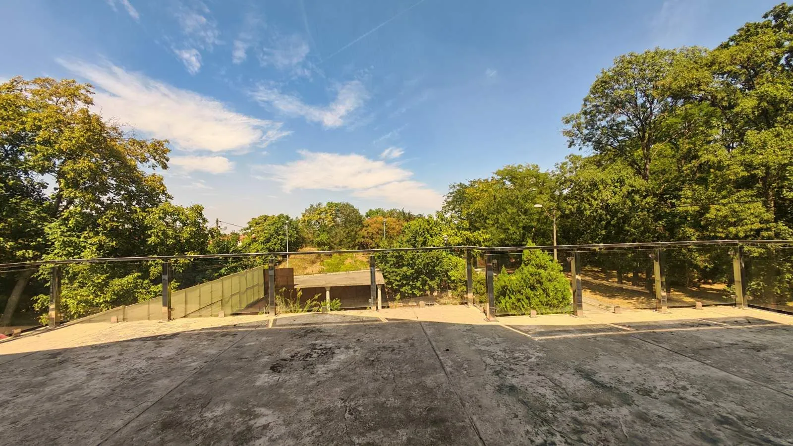 View from the terrace overlooking surrounding greenery and yard.