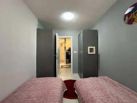 Bedroom with two beds and wardrobes. - image 13