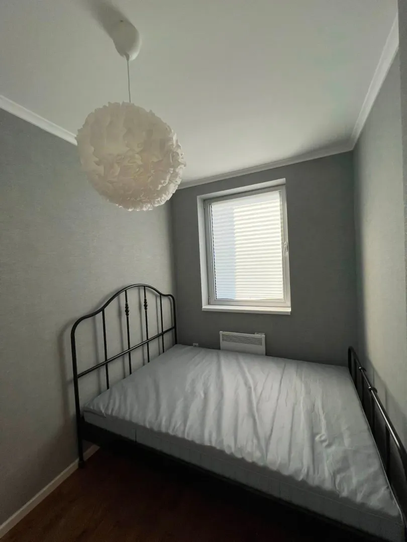 Small bedroom with a double bed and a window.