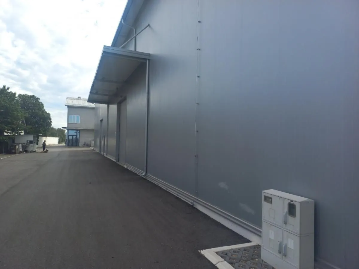 Exterior view of the industrial building with an asphalt driveway.