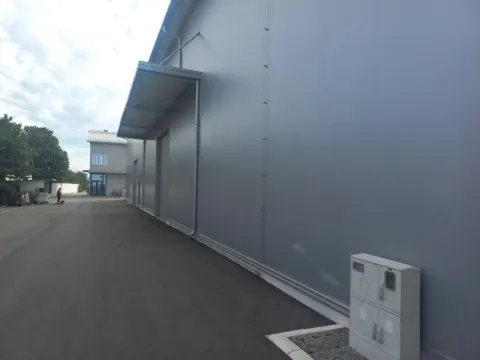 Exterior view of the industrial building with an asphalt driveway. - image 3