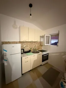 Small equipped kitchen with white goods and a window. - image 4