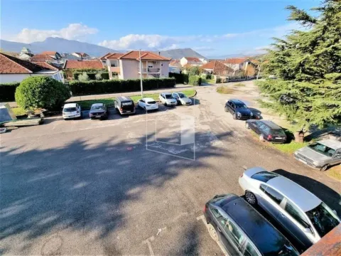 View from the terrace of a parking lot and surrounding houses with hills in the background. - image 2