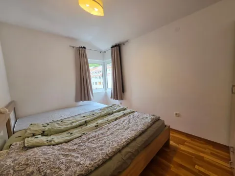 Spavaća soba sa bračnim krevetom i prozorom u uglu. - image 6