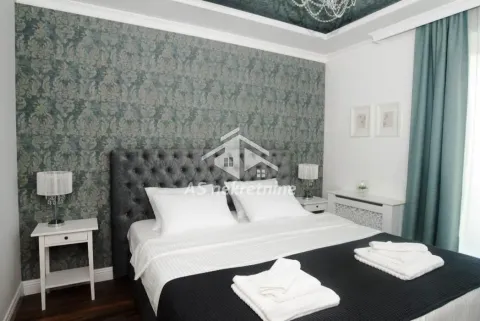 Bedroom with a double bed, patterned wallpaper, and bedside tables. - image 18