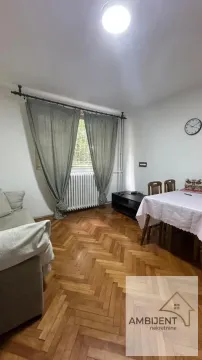 Living room with a sofa, dining table, and parquet flooring. - image 10