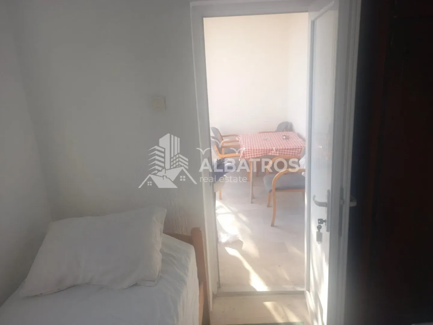 View from the bedroom towards the terrace with a table and chairs.