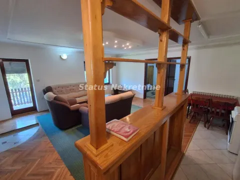 Living room with a sofa set and a wooden partition shelf. - image 6