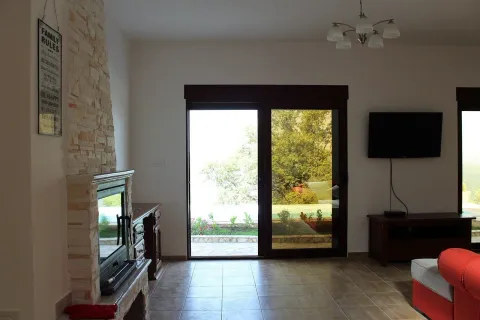 Living room with a fireplace and access to the terrace. - image 15