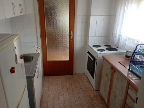 Manja kuhinja sa štednjakom, frižiderom i drvenim elementima. - image 7