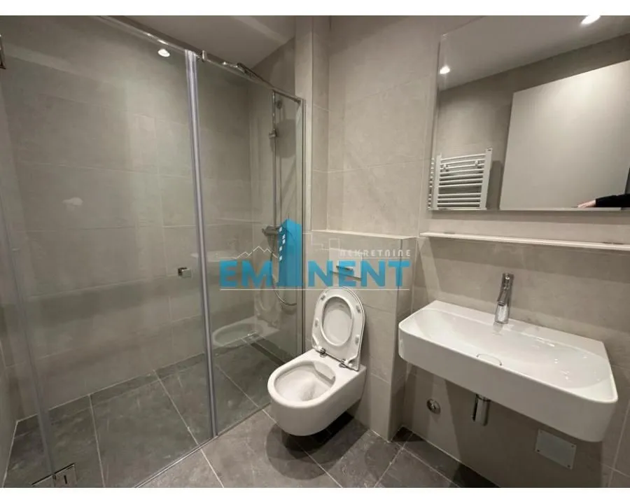 Modern bathroom equipped with a shower cabin and a washbasin.