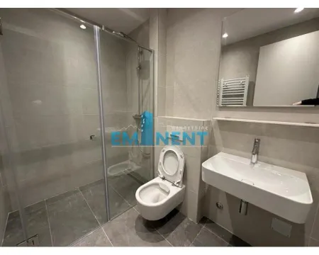 Modern bathroom equipped with a shower cabin and a washbasin. - image 12