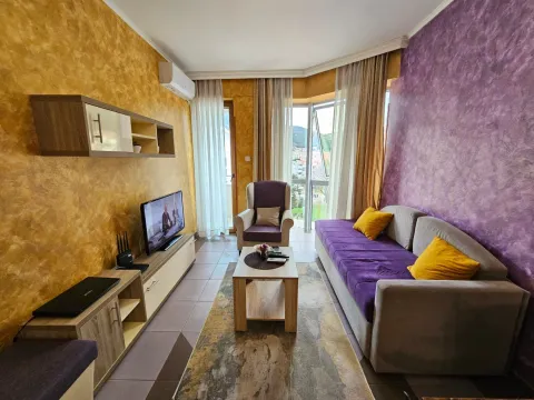Living room with a sofa, TV, and access to the terrace. - image 8