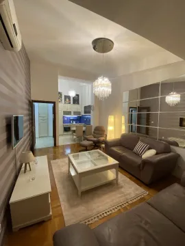Bright living room with leather sofas and a view of the dining area. - image 2