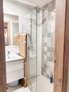 Modern bathroom equipped with a walk-in shower and vanity unit. - image 9
