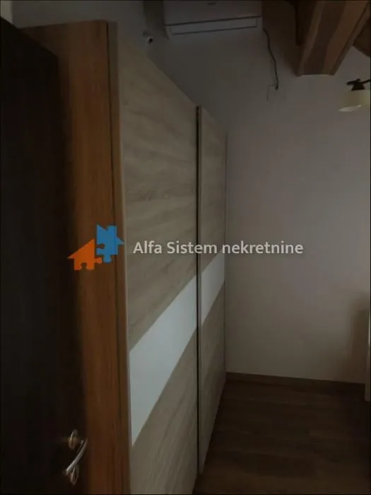 View of the bedroom with a built-in wardrobe and wooden flooring.