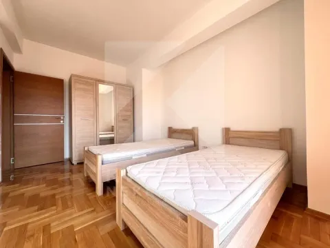 Bedroom with two single beds and a wooden wardrobe. - image 9