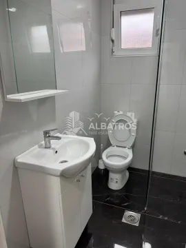 Smaller bathroom with white tiles, washbasin and toilet. - image 5