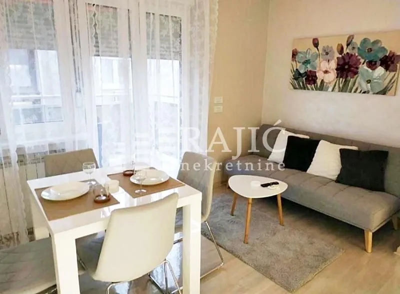 Living room with dining area and sofa.