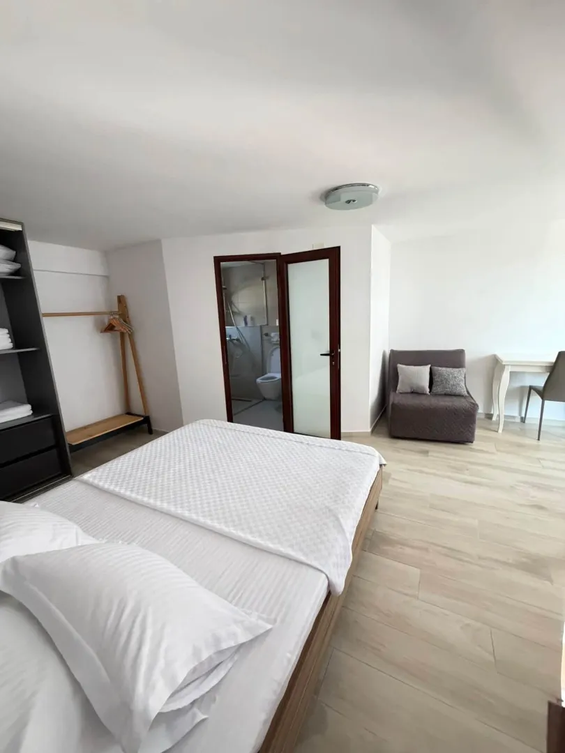 Bright bedroom with a double bed and an en-suite bathroom.