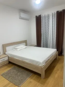 Bedroom with a double bed, nightstands, and an air conditioning unit. - image 7