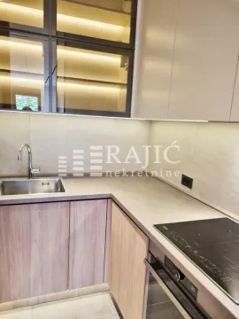 Modern kitchen with built-in appliances and a sink. - image 14